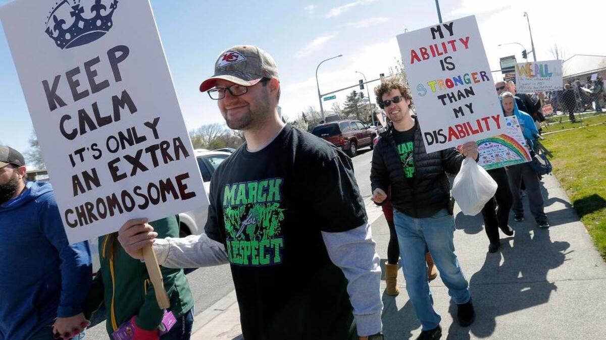 More than 400 people march and hold signs during the March for Respect on Saturday around John Dam Plaza in Richland. The event started with a rally honoring citizens with disabilities.