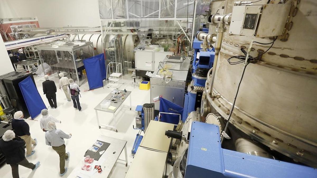 A tour group walks past a tall chamber in May 2015 at the LIGO Hanford facility in Richland before the observatory restarted after a major overhaul to hone its ability to detect gravitational waves. Whether it detected the waves will be revealed Feb. 11.