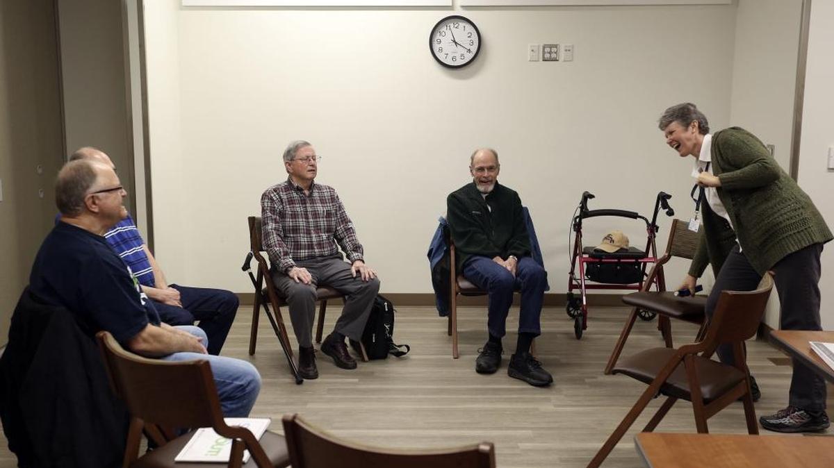 Jenny Davis, right, laughs during a recent voice class for people with Parkinson’s disease. Davis, who also has Parkinson’s, started the class, which meets once or twice a month at the Kadlec Healthplex in Richland.