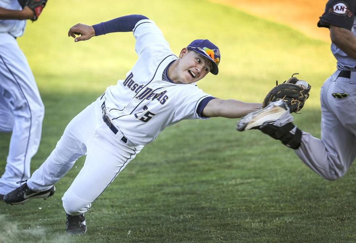 Dust Devil Bryant Aragon (25) attempts to tag out a Salem-Keizer athlete during a baseball game in 2017.