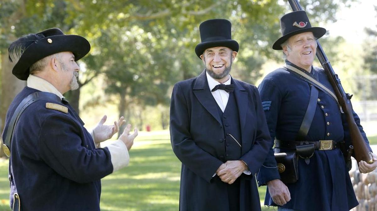 
Civil War actors Richard Bright of Selah, Keith Deaton of Kennewick as President Abraham Lincoln and Glen Allison of Pasco, from left, share a light moment Thursday morning in Columbia Park where they gathered to help the Mid-Columbia Libraries announce their second year presenting, “Civil War: A Living History and Reenactment.” The free two-day event is Sept. 19-20 at Columbia Park.
