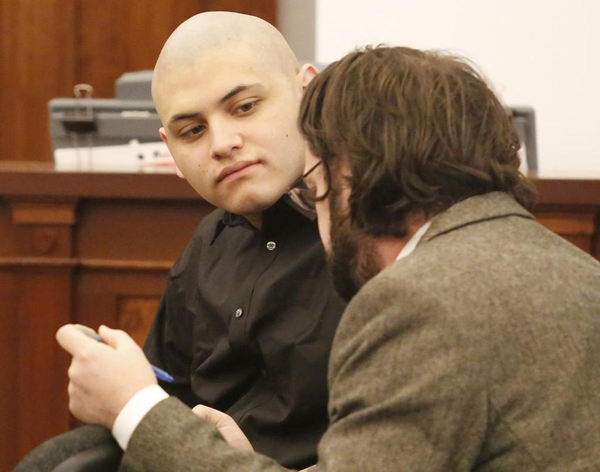 Pedro Cadenas, left, talks with defense lawyer Daniel Stovern during his murder trial in November 2018.