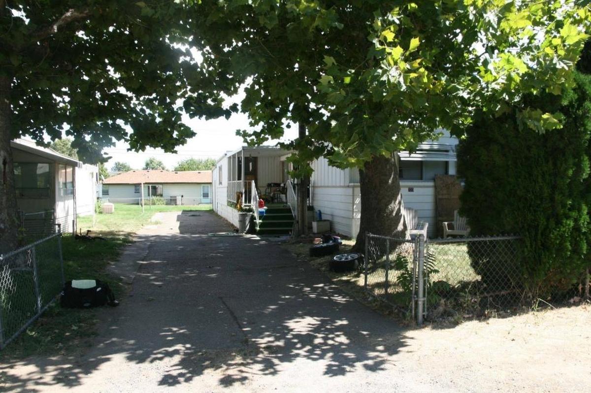 Five people were arrested after serving a warrant at this mobile home in Kennewick after finding a stripped down stolen car.