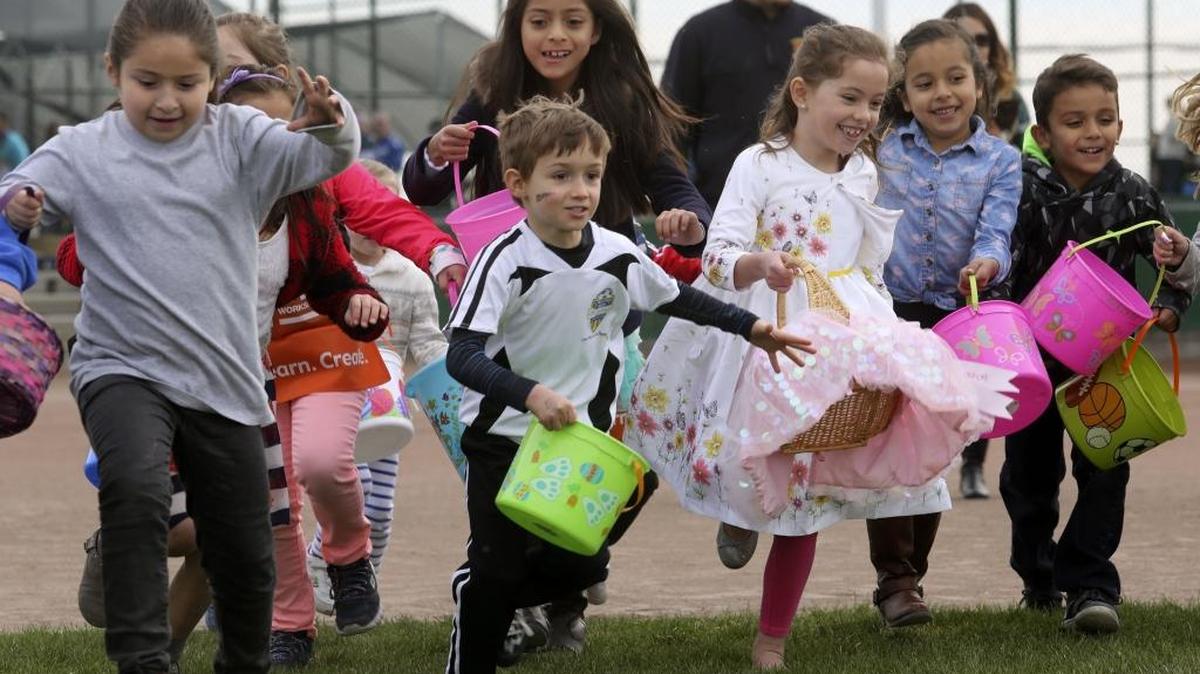 A group of kids runs at the start of the Easter egg hunt Saturday during the Pasco Jaycees Easter Egg Hunt at the TRAC softball complex.
