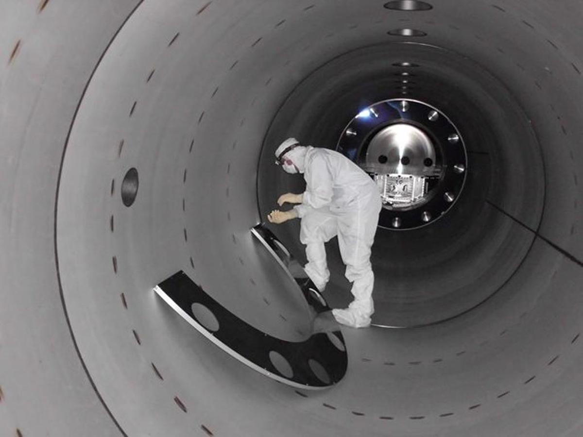 A LIGO technician installs equipment used to control stray light as a part of the Advanced LIGO auxiliary optics system.