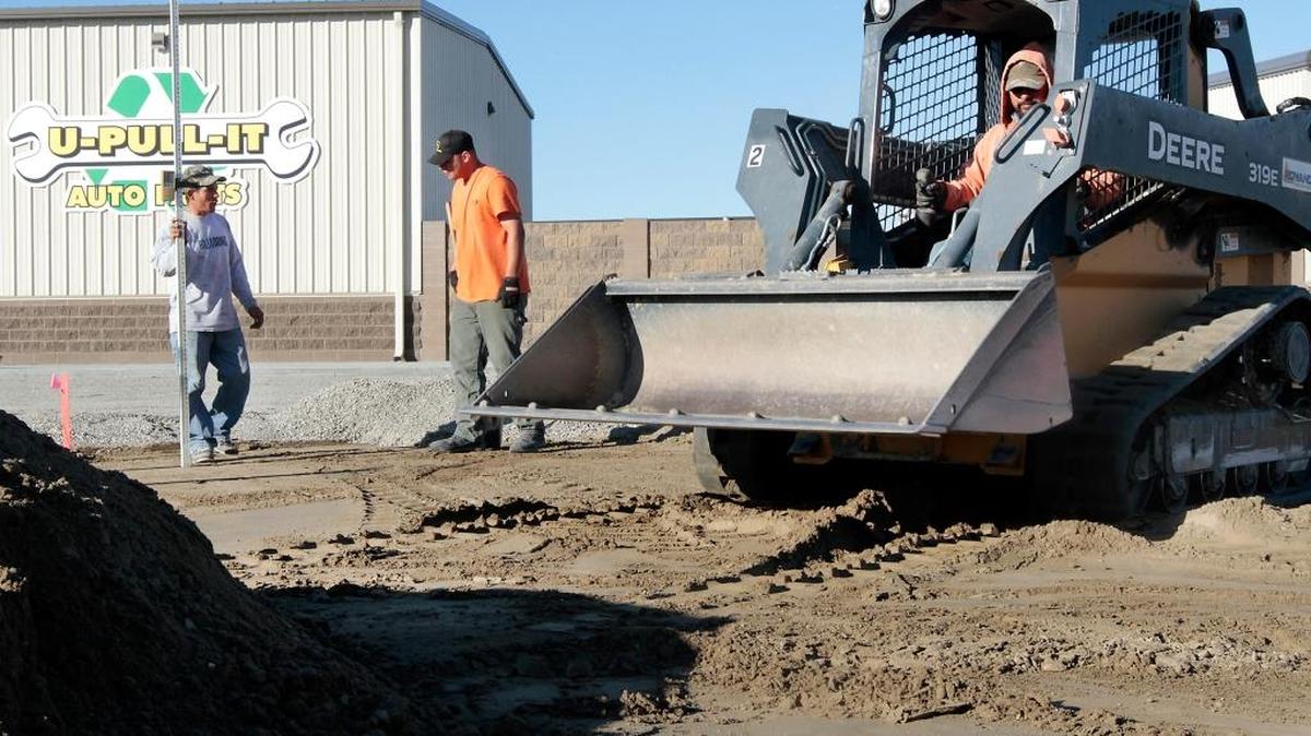 
Badger Development employees Jose Tejada, Ruben Gonzalez and Esvin Recinos, from left, work Monday morning leveling the main parking lot entry for the new U-Pull-It Auto Parts business under construction at 802 S. Oregon Ave in Pasco. The business specializes in used auto parts and is scheduled to open in February, said owner Mark Forcum. There’s a $2 admission fee, but parts are pre-priced with a one-price business model, Forcum said. For example, a side-view mirror is the same price no matter what make or model of vehicle. The seven-acre lot will have about 800 vehicles in the inventory with most being 2000 model year or newer. Forcum, who also has a U-Pull-It in Yakima, said he will soon be hiring about 12 full-time employees.
