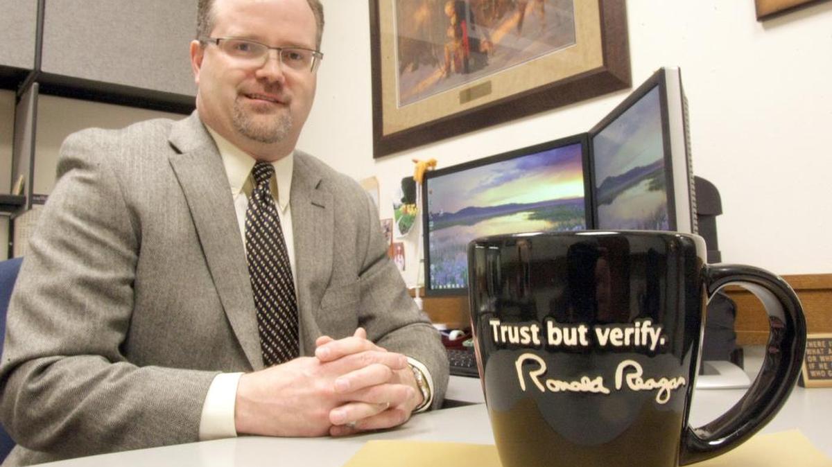 Franklin County Auditor Matt Beaton sits at his desk in 2012 with a coffee cup with Ronald Reagan’s signature phrase “Trust but verify.” Beaton and his staff helped discover the embezzlement of county funds by former Public Works employee Dennis Huston. Huston. The county just finished installing anti-theft software as a result of the crime.