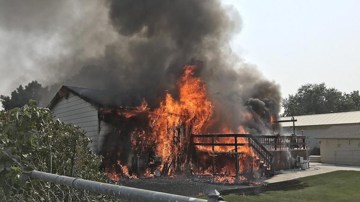 Flames engulf the rear of a house at 33 E. 23rd Avenue Tuesday evening in Kennewick. Fire officials say no one was home when the fire started. Fire agencies from Benton County Fire District 1, Kennewick Fire Department, Richland Fire Department and Pasco Fire Department responded. No one was injured. Watch a video at tricityherald.com/video
