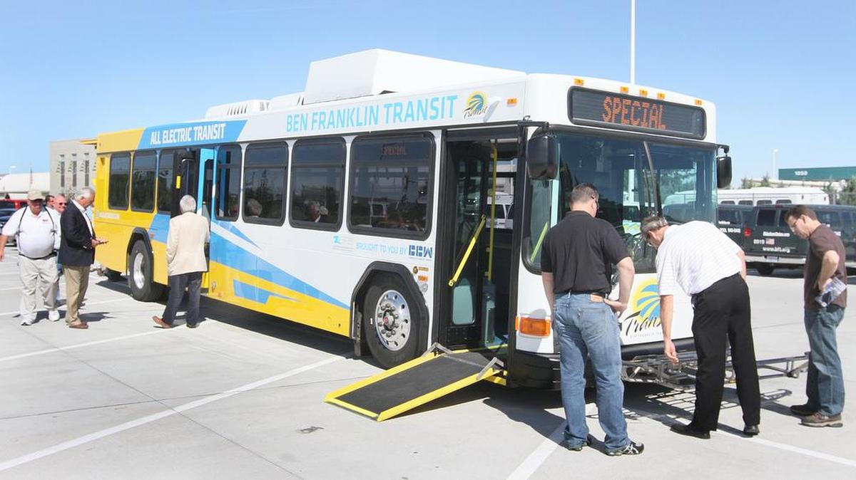 Officials look over a new Ben Franklin Transit electric bus in Richland.