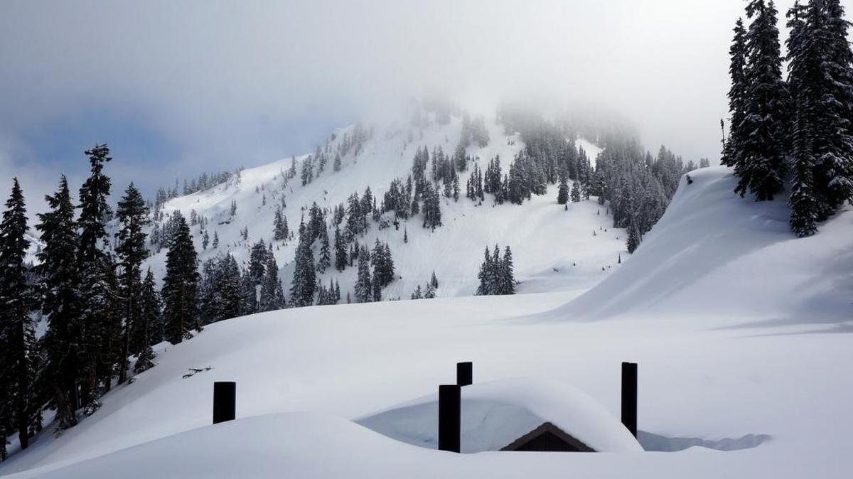 A image from 2017 shows the restrooms near Chinook Pass buried under snow. The passes are typically closed each year.