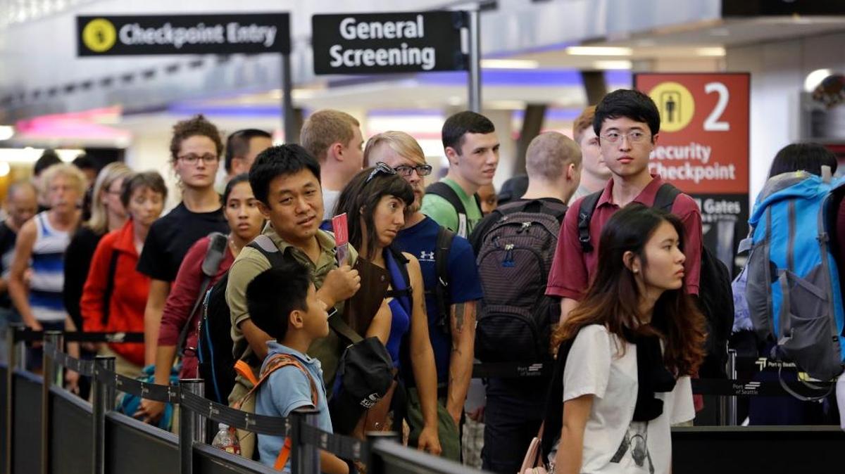 Travelers wait in a security line at Seattle-Tacoma International Airport.