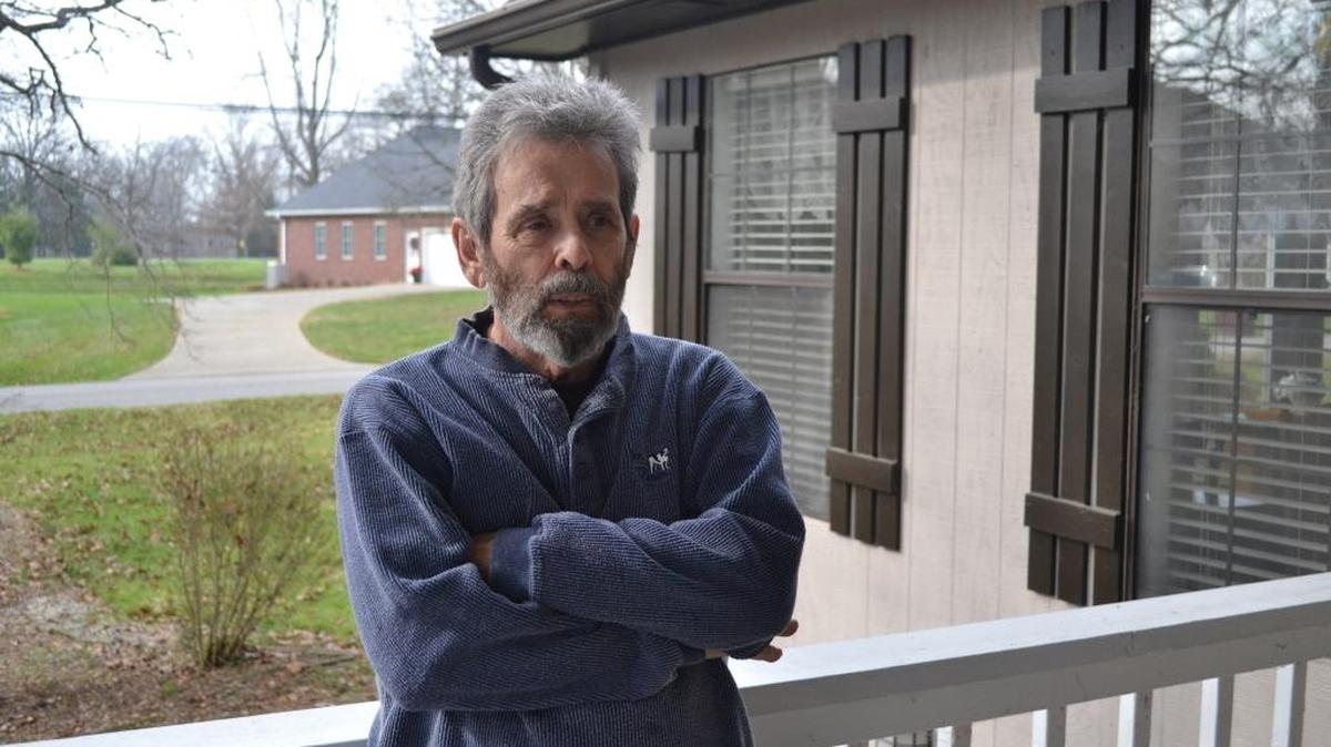 Mike Campbell stands outside his home in Brandenburg, Ky. On Sept. 14, 1989, Campbell, then a 51-year-old pressman, sat down in the break room that morning with a cup of coffee and a newspaper at the Standard Gravure plant in downtown Louisville, Ky. He heard a commotion but thought nothing of it; the pressroom was always thundering with men shouting and machines banging. Then the door swung open and a man stood there with an AK-47.
