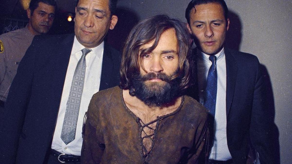 Charles Manson is escorted to his arraignment in Los Angeles on conspiracy-murder charges in connection with the 1969 Sharon Tate murder case. That same year, a young woman was viciously stabbed to death and found not far from the notorious murders by Manson’s followers.