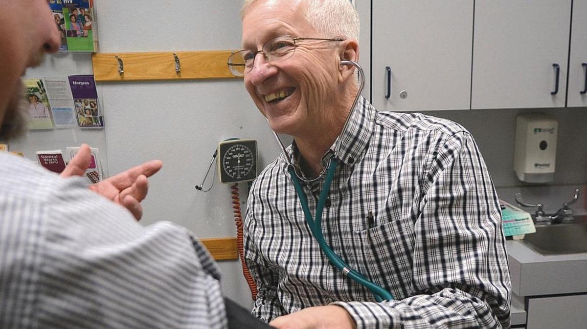 Dr. Glenn Jefferson laughs while seeing a patient in December at the Snake River Clinic, which he founded in Lewiston. The northern Idaho doctor who created the free medical clinic 16 years ago continues to volunteer his services.