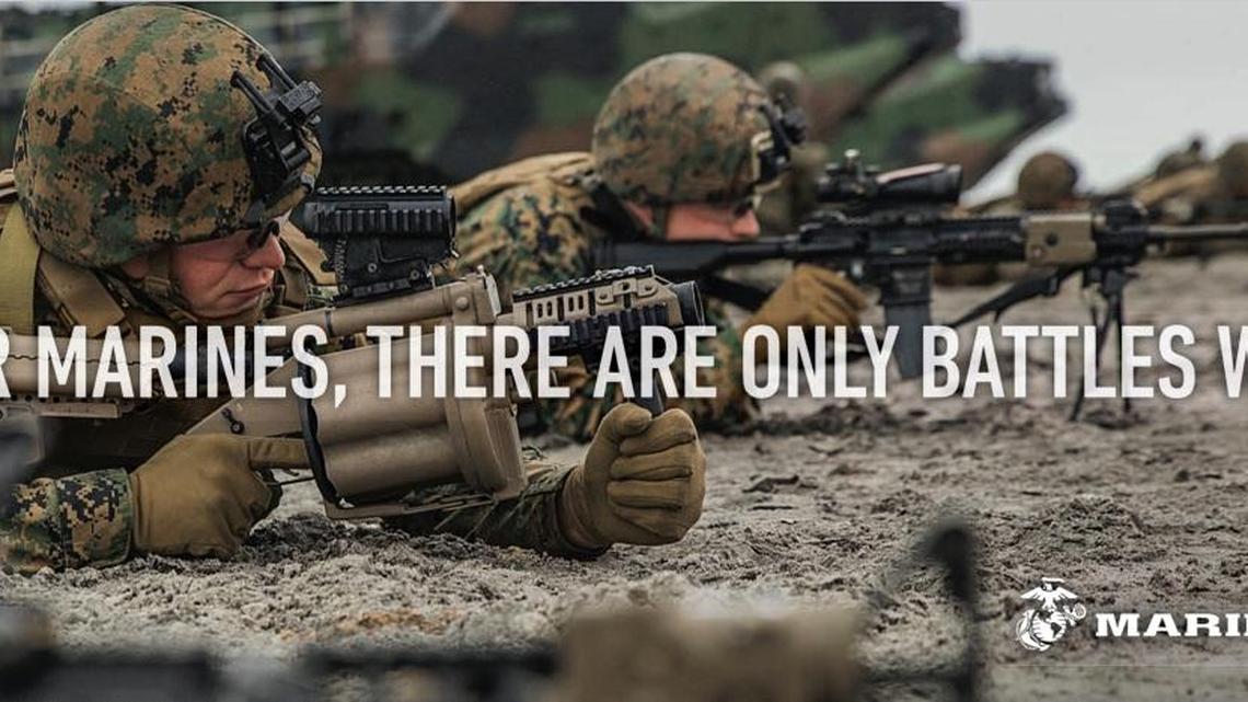 This undated image provided by the Marine Corps, shows a billboard the Corps will post as part of a new recruitment advertisement campaign, meant to draw millennials by showing Marines as not only strong warriors but good citizens. “Battles Won” is the name of the campaign that includes TV ads and online clips of Marines unloading Toys for Tots boxes and real video of a Marine veteran tackling an armed robber. The military’s smallest branch is also considering replacing its iconic slogan, “The Few. The Proud. The Marines”