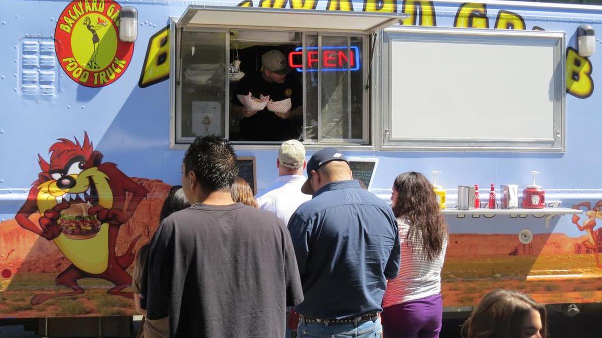 Tri-Citians line up for lunch at Pasco’s Food Truck Friday event. A new law in Washington requires all mobile food trucks to have a state permit and inspection.