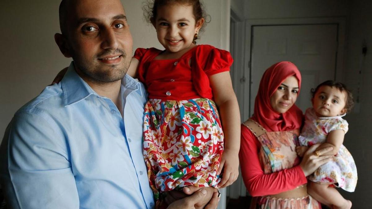 Othman Aljanabi, an Iraqi living in Fort Worth after serving as an interprter to U.S. forces in Iraq, poses for a portrait with his wife Zahraa and daughters Melak, 3, left, and Meera, 9 months.