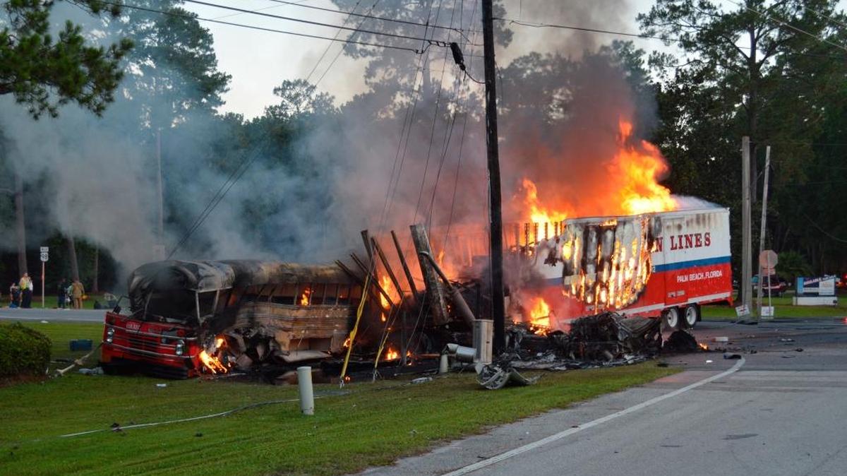 A school bus carrying dozens of mostly Haitian migrant farmworkers burns July 2 after being hit by a tractor-trailer in St. Marks, Fla. Police said the bus driver went through a flashing red light, killing four people, including a 4-year-old boy.