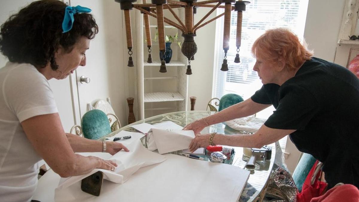 Mischa Greenberg, owner/president of Moves-Made-EZ, left, works with Donna Lupschutz to pack her things as she prepares to downsize at Lupschutz’s home in Bryn Mawr, Pa.