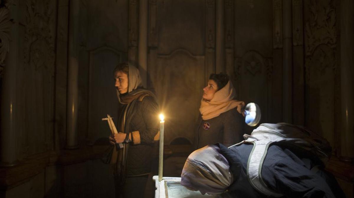 A woman prays at the tomb where most Christians believe Jesus was placed after he was crucified in Jerusalem’s Old City. Three branches of Christianity are undertaking a $3.4 million renovation of the shrine holding Jesus’ tomb in the Church of the Holy Sepulcher in Jerusalem.