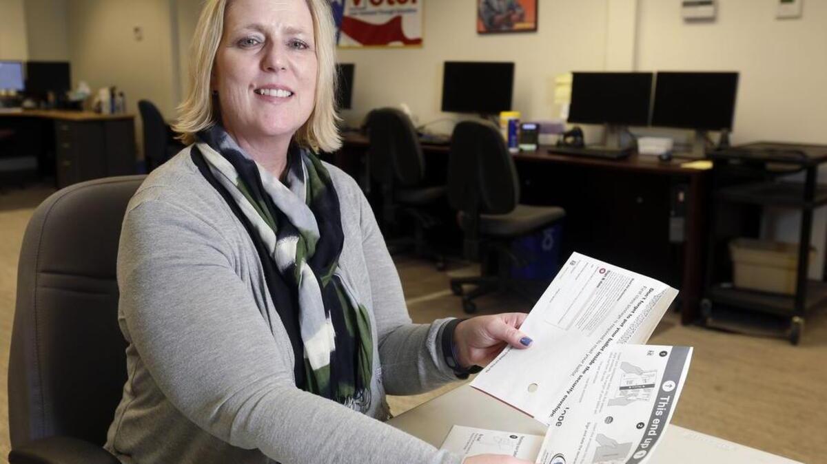 Benton County Auditor Brenda Chilton demonstrates Friday how the new open-ended ballot sleeves are used. With the latest election, Benton joins a growing list of counties to abandon sealable secrecy envelopes in favor of open-ended sleeves. See a video on how to use them at www.tricityherald.com/video.