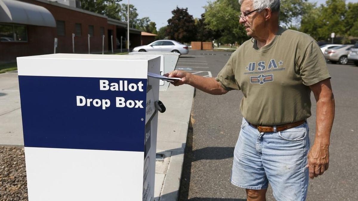 Vic Varick, of Kennewick, drops off ballots for the primary election earlier this year into the ballot drop box at Kennewick City Hall.