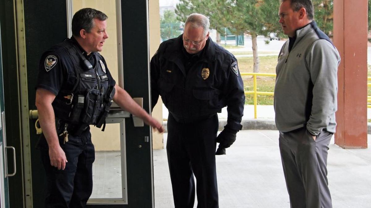 A point of emphasis at a recent Richland High lockdown drill was checking every exterior door to make sure the doors were locking automatically. Seen here are RHS Principal Tim Praino and Richland police officers checking one of the locking mechanisms.