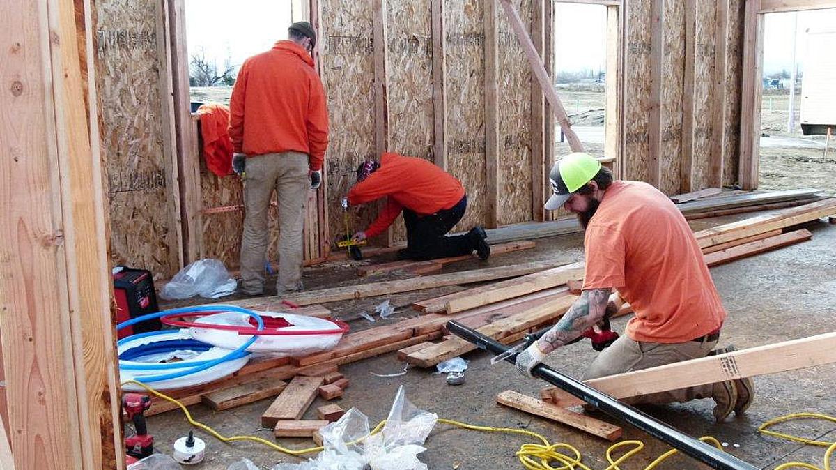 Members of the Local Union 598 Plumbers and Steamfitters volunteer on a house.