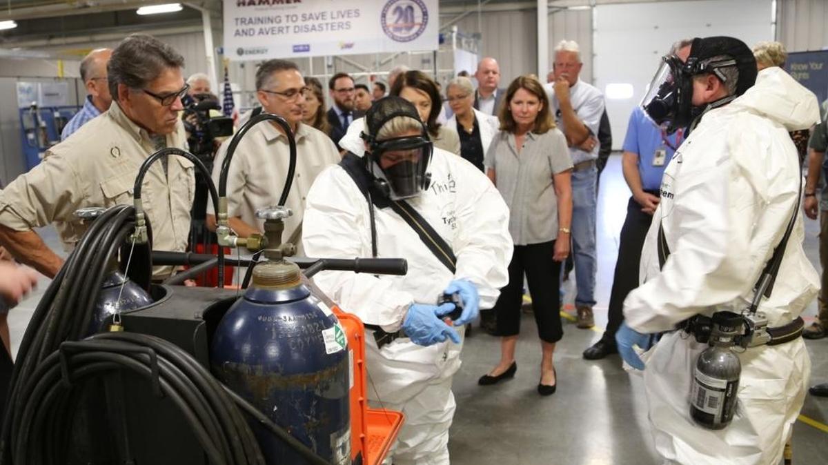 Secretary of Energy Rick Perry participates in a worker trainer-led respiratory demonstration during his tour at HAMMER.