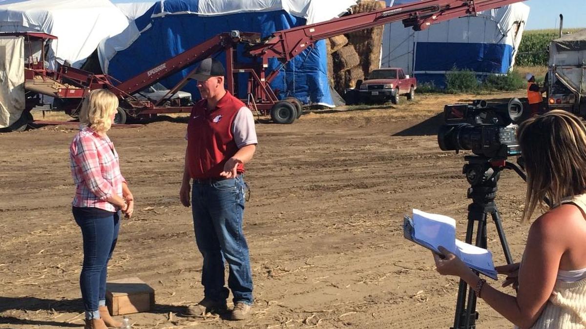 Host Kristi Gorenson with farmer Rob Davis of Connell during farm segment filming.