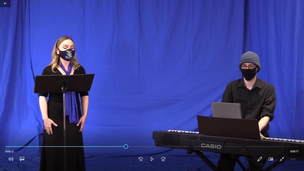  Soprano Molly Holleran and pianist Ben Walley perform for video in front of a blue screen in fall 2020, following masking and social distancing protocols. Blue screens give video editors the option to add backgrounds and change the look of the video.