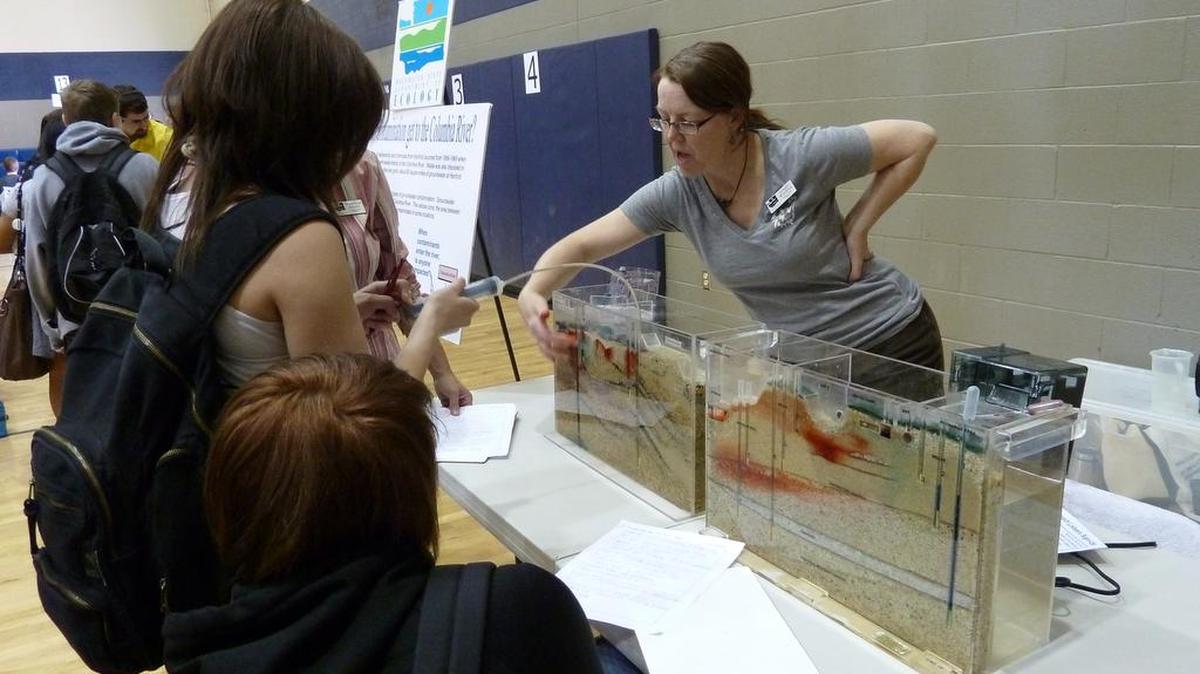Ginger Wireman, outreach specialist for state Ecology’s Nuclear Waste Program in Richland, shows Tri-Cities-area students how contaminants – such as those leaking from Hanford’s underground waste tanks – migrate through soil into groundwater.