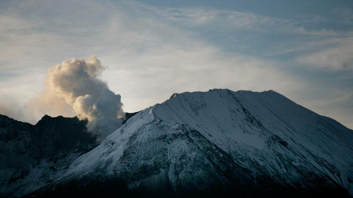 Early morning sun light reflects on the steam released by Mount St. Helens.