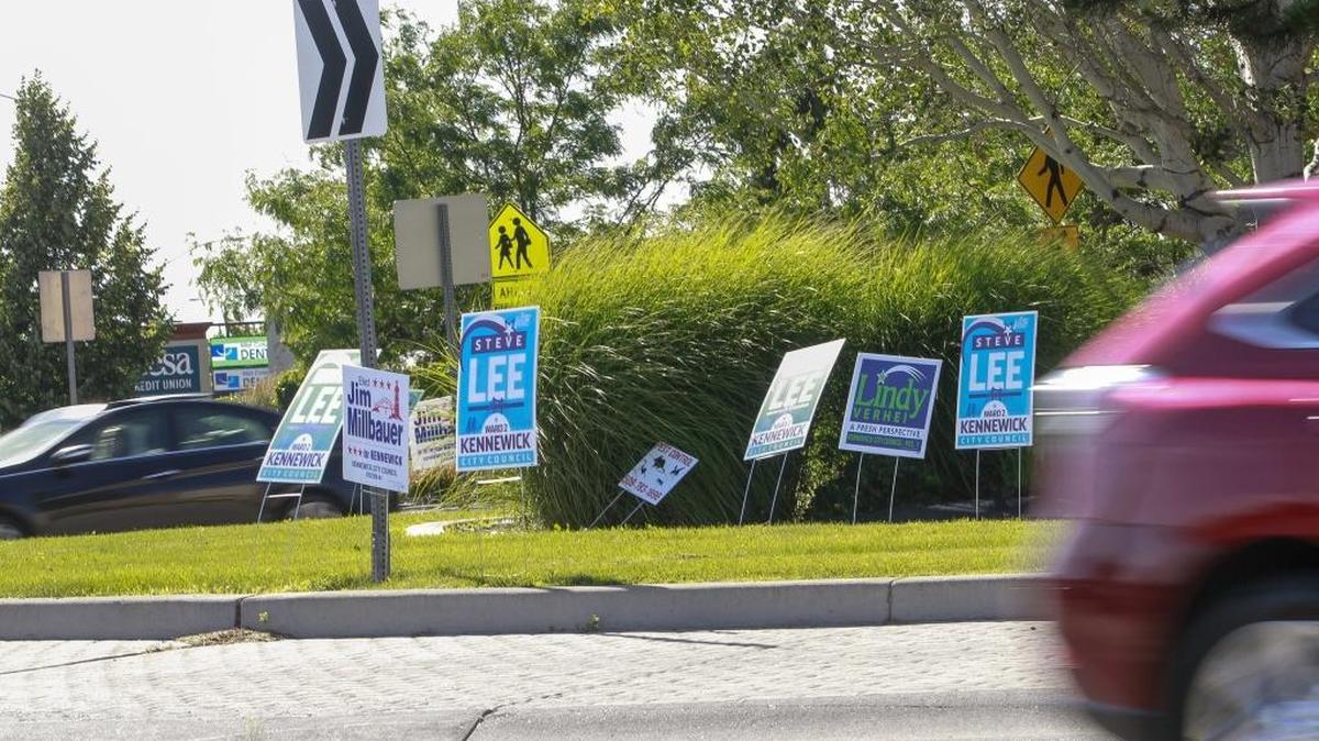 Campaign signs dot the roundabout at 27th Street and Union in Kennewick before the primary last summer. Any remaining campaign signs in the Tri-Cities should be removed as soon as possible.