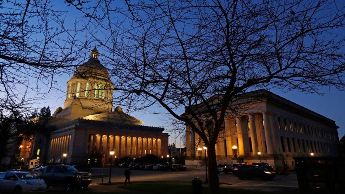 The Legislative (left) and Insurance buildings are show at dusk at the Capitol in Olympia on Dec. 4, 2018. Once covered by as many as 30 reporters, the decline in the size of newspaper newsrooms has resulted in a smaller number of statehouse reporters. About six regularly cover the state government from Olympia bureaus, according to the Everett Herald.