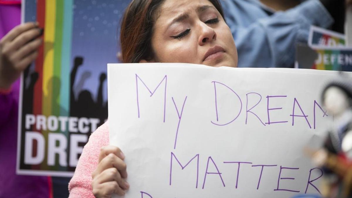 Evelin Hernandez, 27, cries as she holds a sign reading "My dreams matter. Don't shatter them," during a protest in front of the Hennepin County Jail in Minneapolis after President Donald Trump announced his plans to rescind DACA in September 2017. Washington state lawmakers are working hard to push legislation through that would provide a permanent solution.