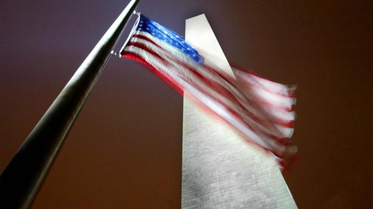 An American flag flies next to the Washington Monument in Washington, D.C.