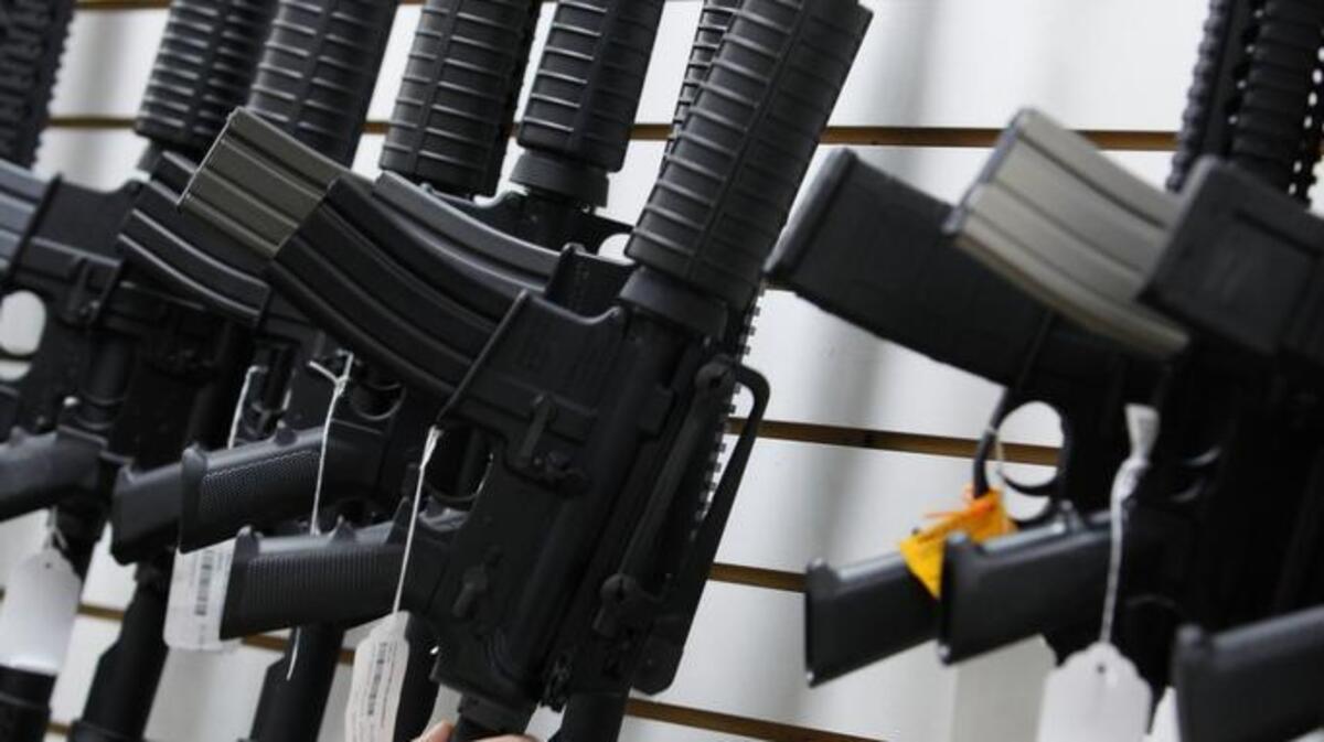 In this April 6, 2010, file photo, an Arizona made AR-15 is pulled from the display at Caswells Shooting Range in Mesa, Ariz. The Arizona Senate is set to debate legislation Monday, March 30, 2015 that would allow residents with concealed carry permits to bring their guns into government buildings.