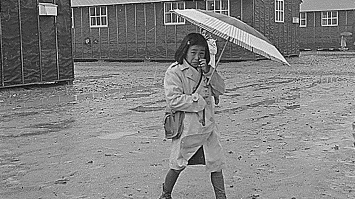 A Japanese-American girl walks through mud at the Jerome Relocation Camp near Jerome, Ark., in this March 12, 1943, photo.