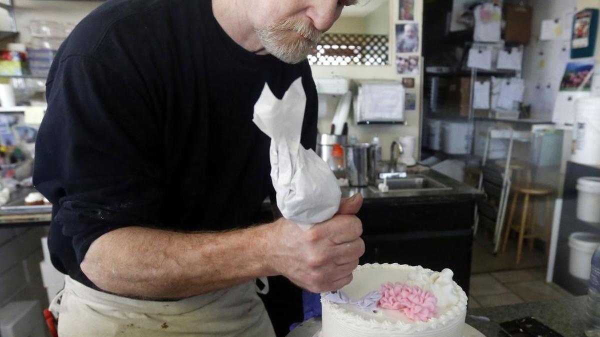 In this 2014, file photo, Masterpiece Cakeshop owner Jack Phillips decorates a cake inside his store in Lakewood, Colo. The Supreme Court set aside a Colorado court ruling against Phillips for refusing to make a wedding cake for a same-sex couple because of his religious beliefs.