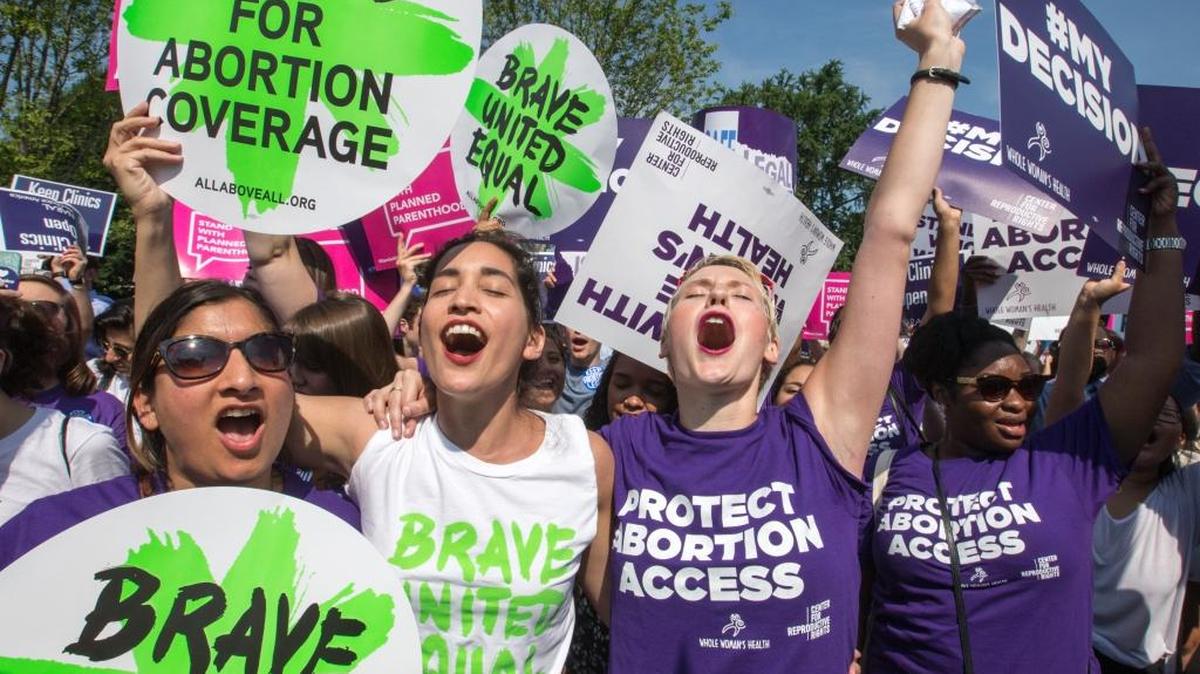 Abortion rights activists, from left, Ravina Daphtary of Philadelphia, Morgan Hopkins of Boston, and Alison Turkos of New York City, rejoice in front of the Supreme Court in Washington on June 27, as the justices struck down the strict Texas anti-abortion restriction law known as HB2. Other cases are to follow on guns, and public corruption.
