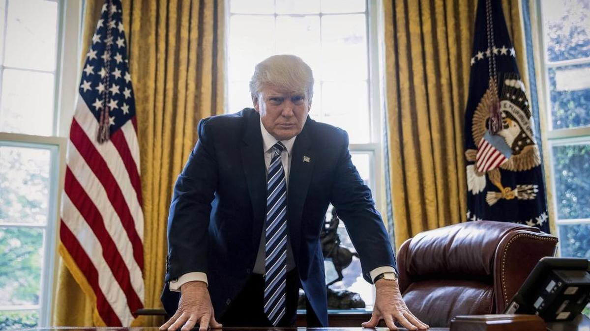 President Donald Trump poses for a portrait in the Oval Office in Washington after an interview with The Associated Press. Trump can claim credit for hijacking the term “fake news” for his own political ends, says Erik Wemple of The Washington Post.