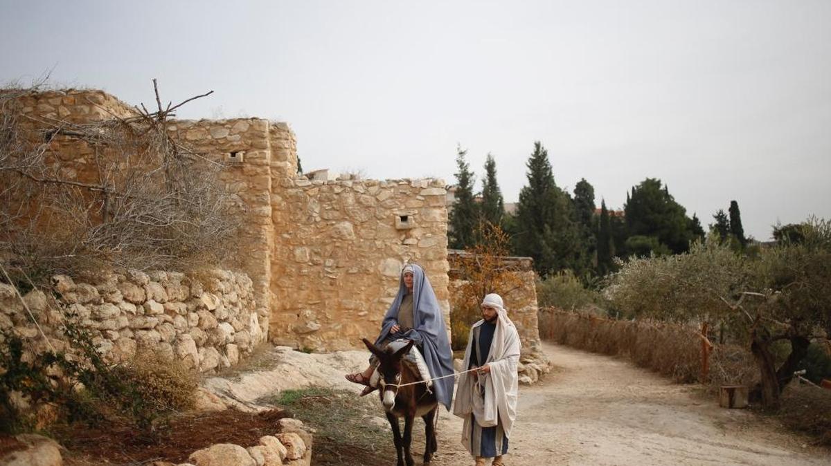 Christian actors portray Joseph and Mary during a re-enactment of a Nativity scene of the journey to Bethlehem during Christmas festivities at the Nazareth Village in Nazareth, northern Israel, Thursday, Dec. 21, 2017.