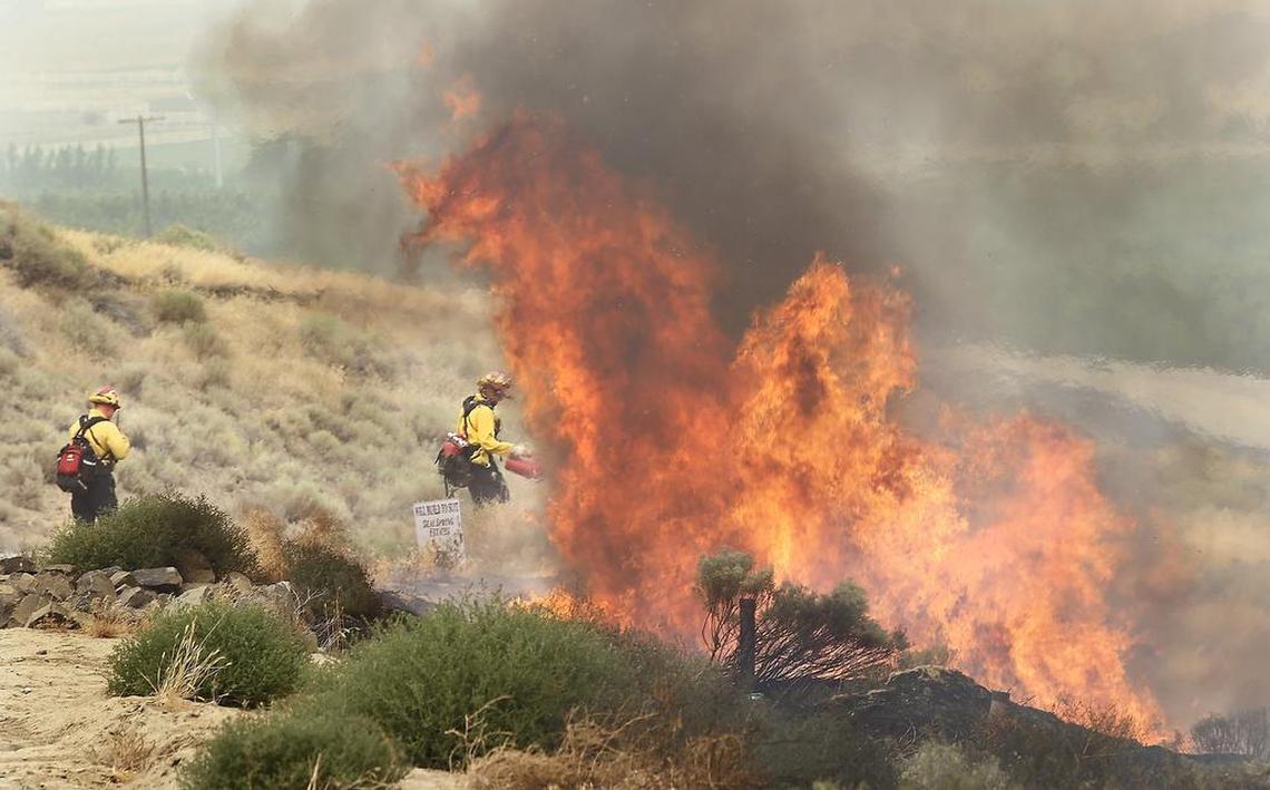 Firefighters start a burn out to halt a fire burning east of Kennewick in 2019. A fire weather watch has been issued for the Tri-Cities on Friday July 15, 2022.
