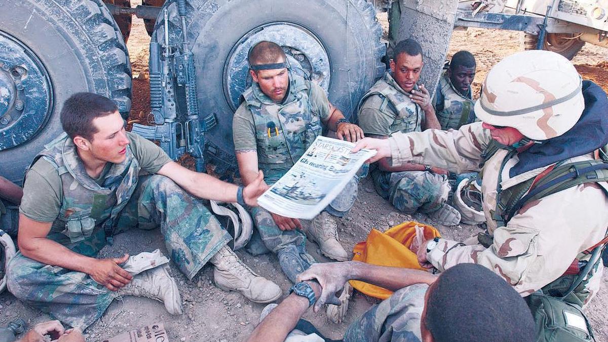 Stars and Stripes is delivered to U.S. Marines during a break in the advance toward Baghdad in April 2003. Stars and Stripes may lose its funding.