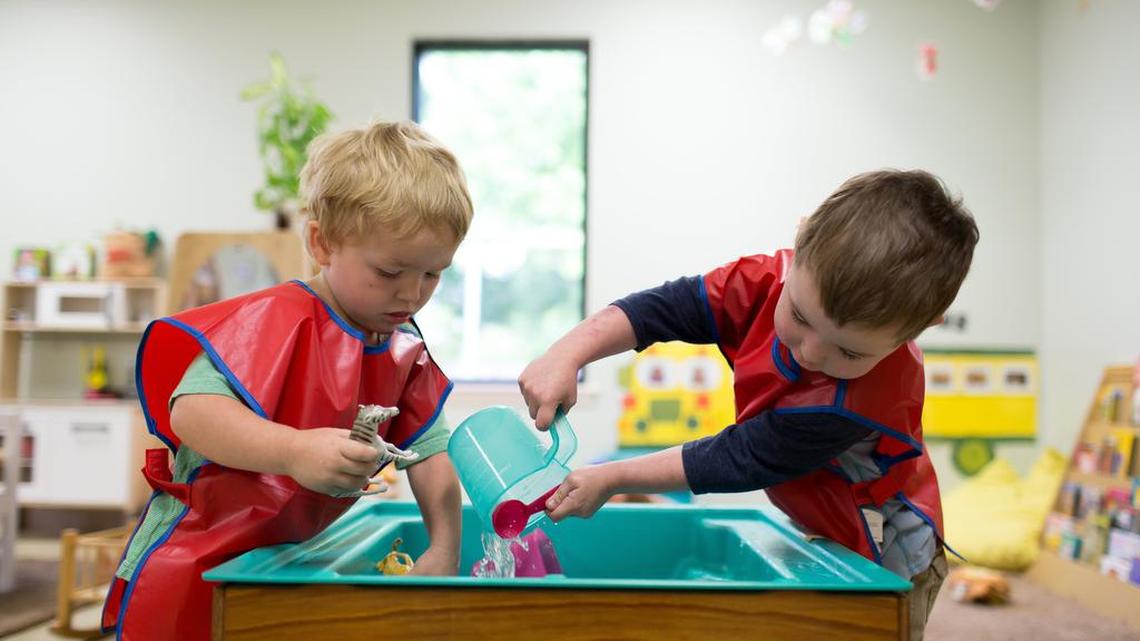 Two youngsters play at the water table inside their Early Head Start classroom at Save the Children's Head Start center in Russellville, Ark., in this file photo.