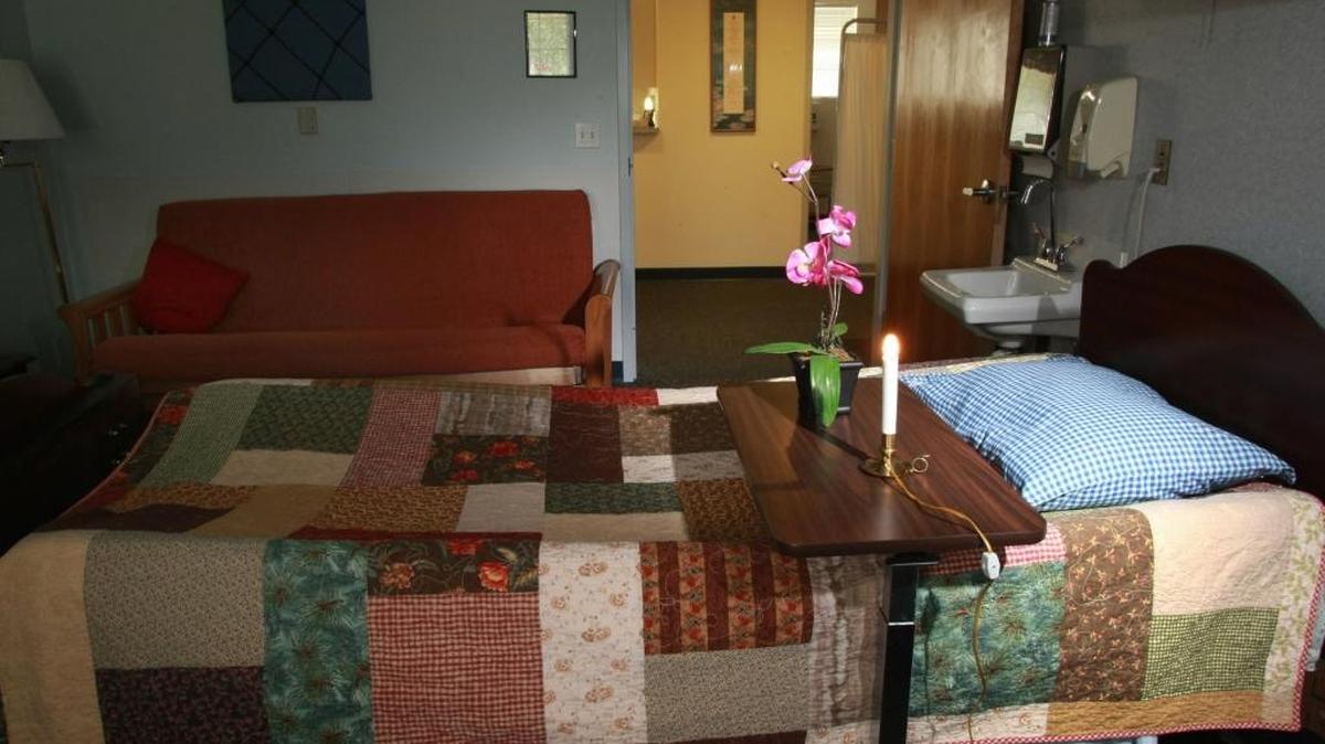 A single candle-style bulb and flowers sit in a room at the Hospice House in Kennewick. Staff place the tribute in each room after a death, and the room is not used for 24 hours. Volunteer Colette Jorgenson says, “We always say we celebrate life at Hospice, not death.”
Herald/Bob Brawdy #1