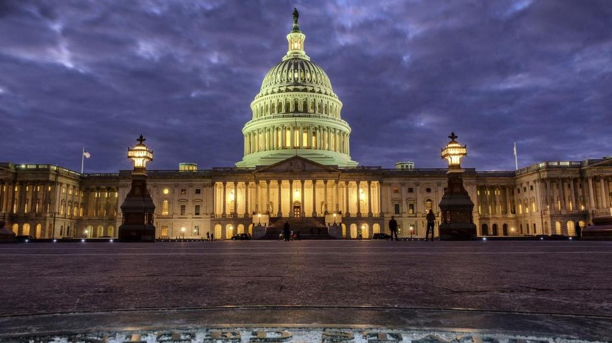 In this Jan. 21, 2018, photo, lights shine inside the U.S. Capitol Building as night falls in Washington, D.C. Lawmakers are working on the Mobile Workforce State Income Tax Simplification Act, which would protect Washington state residents from income taxes when they work out of state.