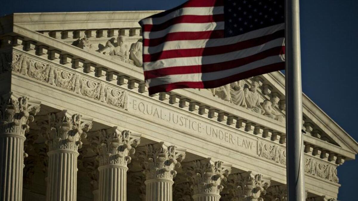 The American flag flies in front of the Supreme Court building in Washington, D.C. The U.S. Supreme Court heard oral arguments last Monday in a landmark case that would allow workers to leave their unions and still keep their jobs.