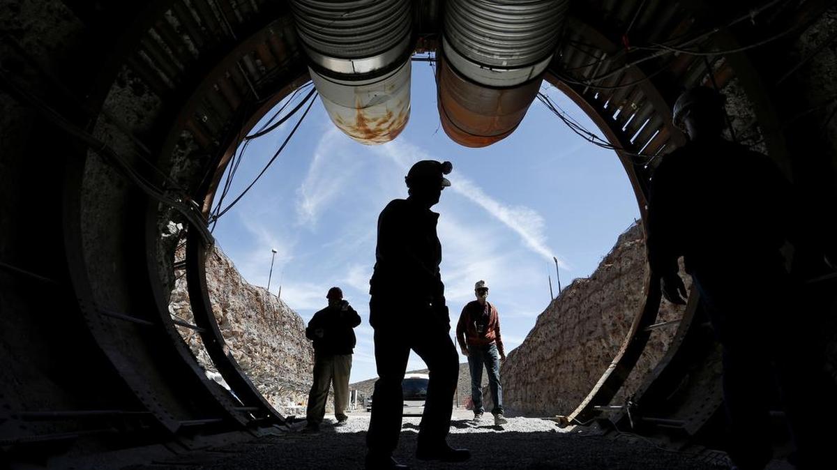 In this April 9, 2015, file photo, people walk into the south portal of Yucca Mountain during a congressional tour of the proposed radioactive waste dump near Mercury, Nev.
